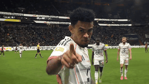 A Soccer Player Giving A Thumbs Up In Front Of A Sign That Says ' Deutsche ' GIF