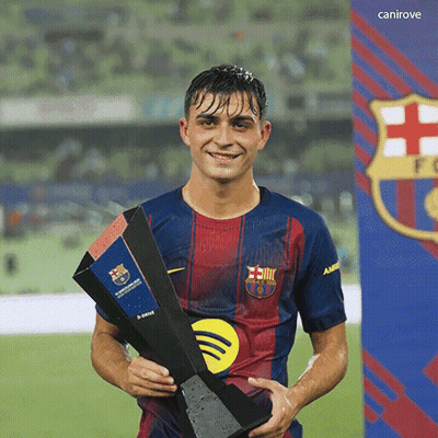 A Soccer Player Holding A Trophy In Front Of A Canirove Sign GIF