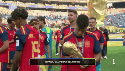 A Soccer Player Holding A Trophy That Says Espana GIF