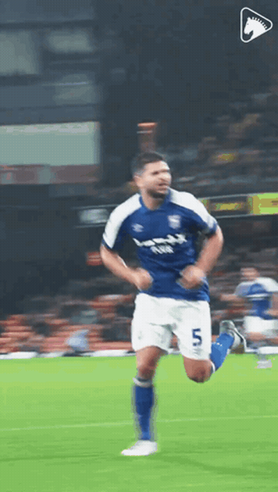 A Soccer Player In A Blue And White Uniform Is Running On A Field . GIF