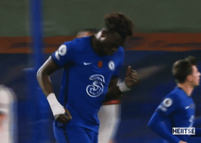A Soccer Player In A Blue Jersey Is Celebrating A Goal During A Soccer Game . GIF