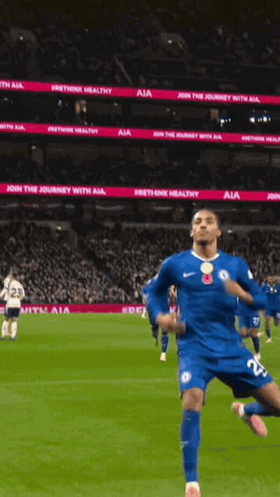 A Soccer Player In A Blue Jersey Is Running On A Field With A Sign That Says Join The Journey With Aia GIF