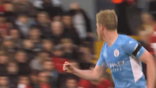 A Soccer Player In A Blue Shirt Is Celebrating A Goal . GIF