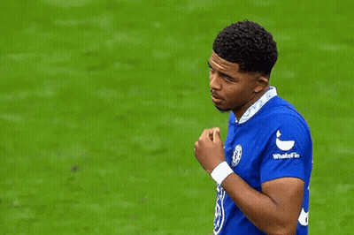 A Soccer Player In A Blue Shirt Is Talking To Another Player On The Field . GIF