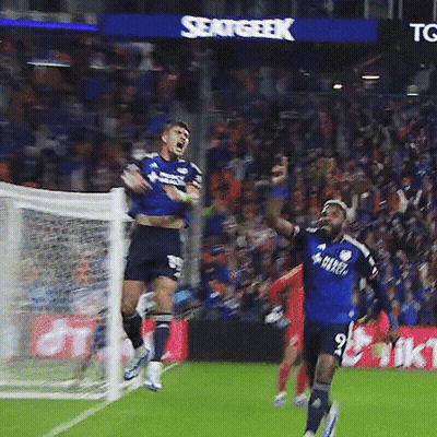 A Soccer Player In A Blue Shirt With The Number 9 On It Jumps In The Air GIF