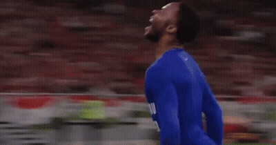 A Soccer Player In A Blue Suit Is Running On A Field GIF