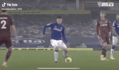 A Soccer Player In A Blue Uniform Is Running Towards The Ball . GIF