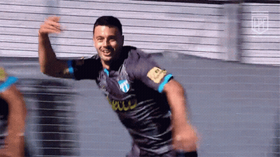 A Soccer Player In A Gray And Blue Jersey Is Celebrating A Goal . GIF