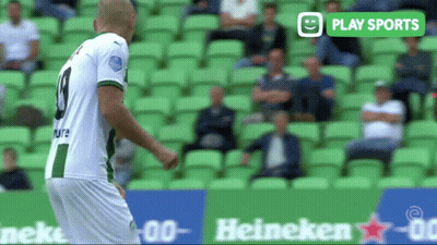 A Soccer Player In A Green And White Jersey With The Number 9 On His Back GIF