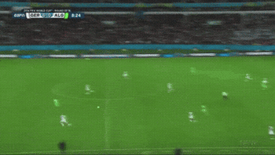 A Soccer Player In A Green Jersey Kicks A Soccer Ball GIF