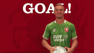A Soccer Player In A Green Pure Energie Jersey Holds A Ball GIF