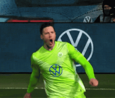 A Soccer Player In A Green Shirt Is Celebrating A Goal On A Field . GIF