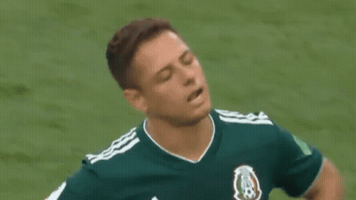 A Soccer Player In A Green Shirt Is Standing On A Field . GIF