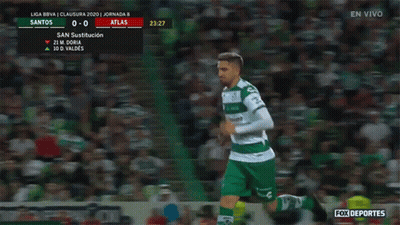 A Soccer Player In A Green Uniform Is Running In Front Of A Crowd GIF