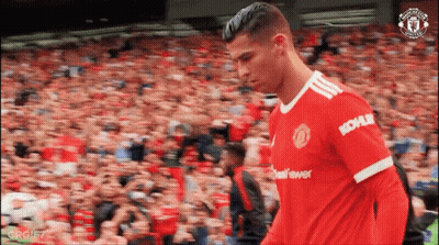 A Soccer Player In A Kohler Jersey Walks In Front Of A Crowd . GIF