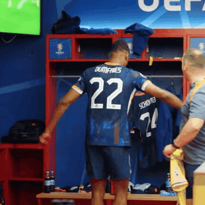 A Soccer Player In A Locker Room With The Number 22 On His Jersey GIF
