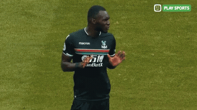 A Soccer Player In A Macron Jersey Talks To A Referee GIF