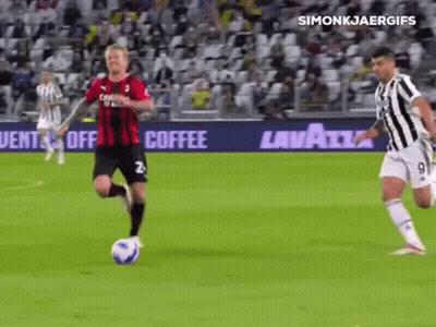 A Soccer Player In A Red And Black Jersey Is Running With The Ball GIF
