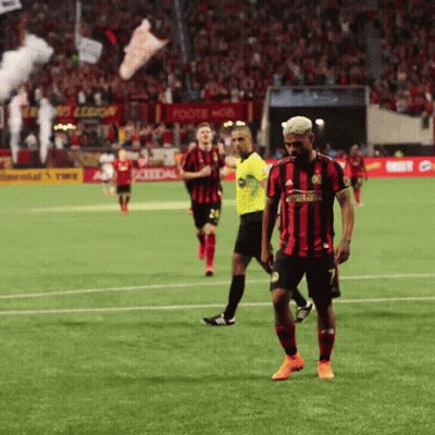 A Soccer Player In A Red And Black Jersey With The Number 7 On It GIF