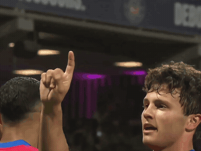A Soccer Player In A Red And Blue Jersey With Akw On His Back GIF