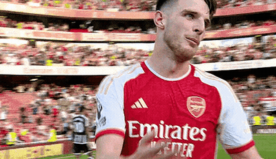 A Soccer Player In A Red And White Emirates Jersey Is Giving A Thumbs Up . GIF