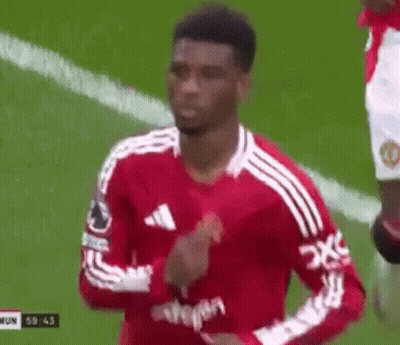 A Soccer Player In A Red And White Jersey Is Running On A Soccer Field . GIF