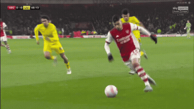 A Soccer Player In A Red Emirates Uniform Kicks A Soccer Ball GIF