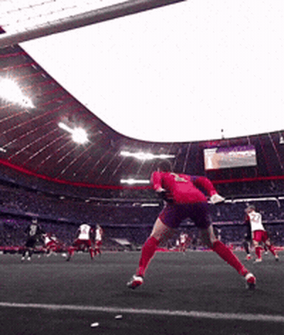 A Soccer Player In A Red Jersey Is Jumping In The Air To Catch A Ball GIF