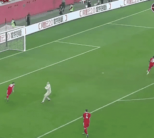 A Soccer Player In A Red Jersey Runs Towards A Ball GIF