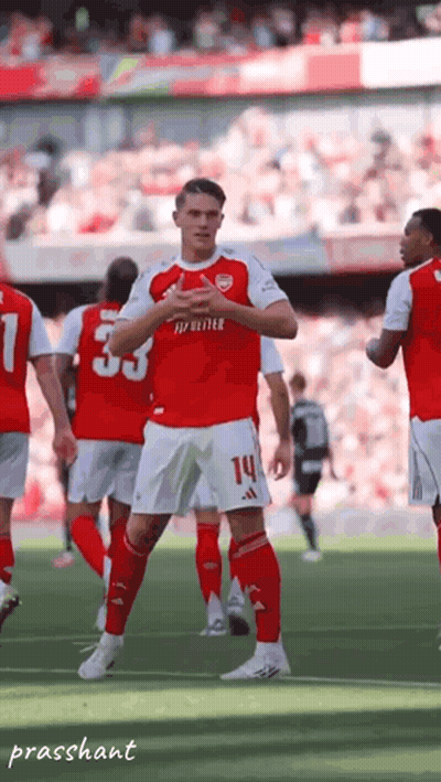 A Soccer Player In A Red Jersey With The Number 14 On His Shorts GIF