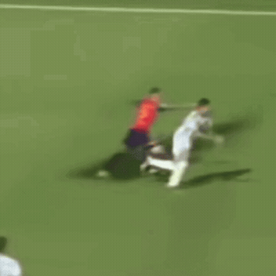 A Soccer Player In A Red Shirt Is Doing A Trick On A Soccer Field . GIF