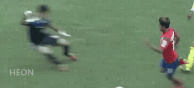 A Soccer Player In A Red Shirt Is Running On A Field . GIF