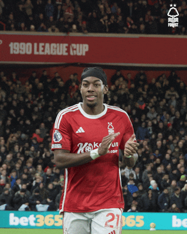 A Soccer Player In A Red Shirt With The Number 21 On His Shorts GIF
