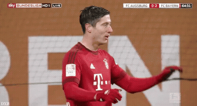 A Soccer Player In A Red T-Mobile Jersey Is Standing In Front Of A Large T-Mobile Sign . GIF