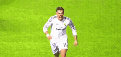 A Soccer Player In A White Jersey Is Running On A Soccer Field . GIF