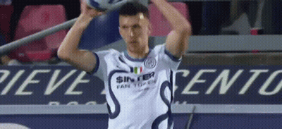 A Soccer Player In A White Shirt Is Holding A Soccer Ball In His Hands . GIF