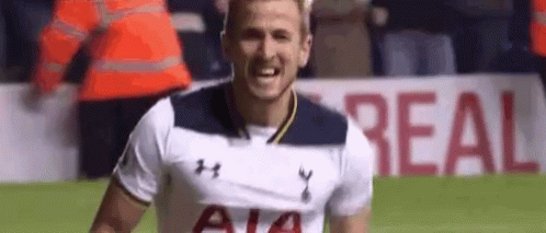 A Soccer Player In A White Shirt Is Smiling On The Field . GIF