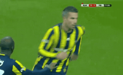 A Soccer Player In A Yellow And Blue Striped Shirt Is Being Tackled By Another Player On The Field . GIF