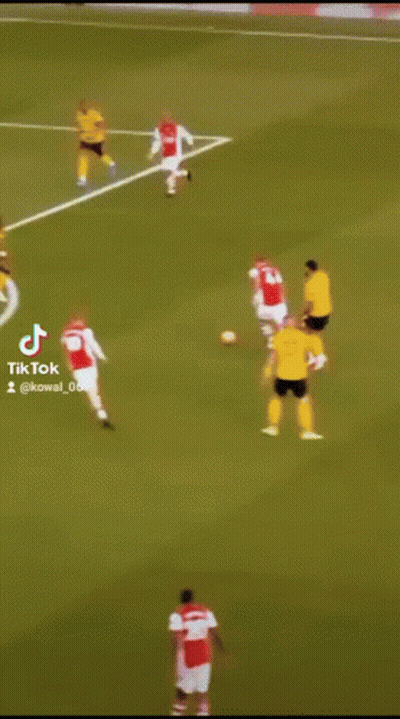 A Soccer Player In A Yellow Jersey Is Kicking A Ball GIF