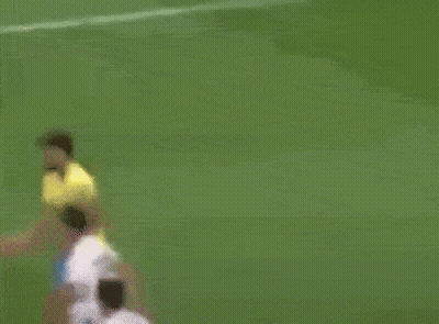 A Soccer Player In A Yellow Shirt And Blue Shorts Is Kicking The Ball GIF