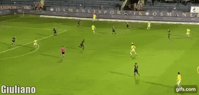 A Soccer Player In A Yellow Shirt Is Celebrating A Goal On The Field . GIF