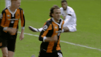 A Soccer Player In An Orange And Black Jersey With The Number 3 On The Front GIF