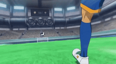 A Soccer Player In Blue Socks Is Kicking A Soccer Ball On A Field . GIF