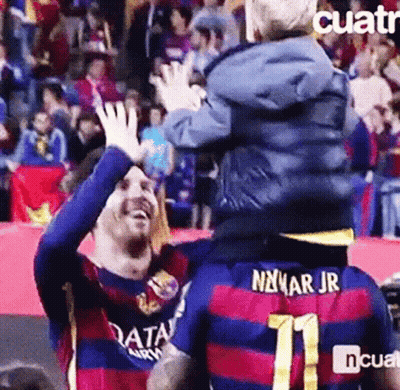 A Soccer Player Is Carrying A Child On His Shoulders And The Child Is Wearing A Number 11 Jersey . GIF