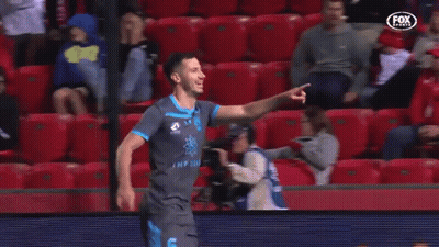 A Soccer Player Is Celebrating A Goal In Front Of A Crowd Of People . GIF