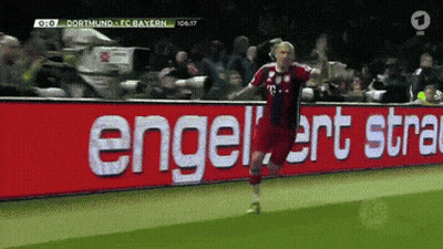 A Soccer Player Is Celebrating A Goal In Front Of A Sign That Says Engelert Stra GIF