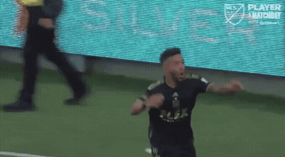 A Soccer Player Is Celebrating A Goal On A Field GIF
