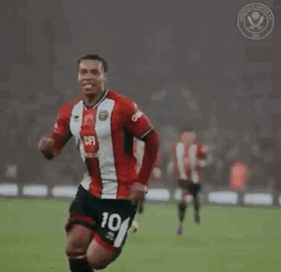 A Soccer Player Is Celebrating A Goal On A Field With His Teammates . GIF