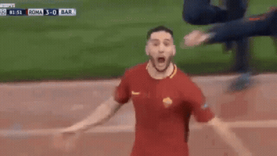 A Soccer Player Is Celebrating A Goal With His Arms Outstretched On A Soccer Field . GIF