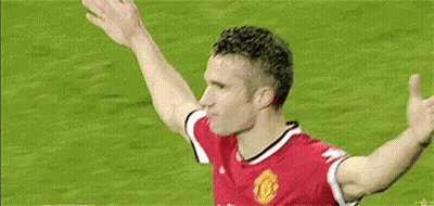 A Soccer Player Is Celebrating A Goal With His Arms Outstretched On A Soccer Field . GIF